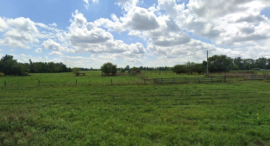 green pastures with blue sky