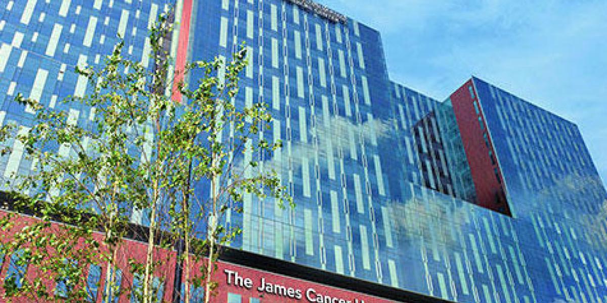 photo of the facade of the James Cancer Institute, from ground level looking up to the sky