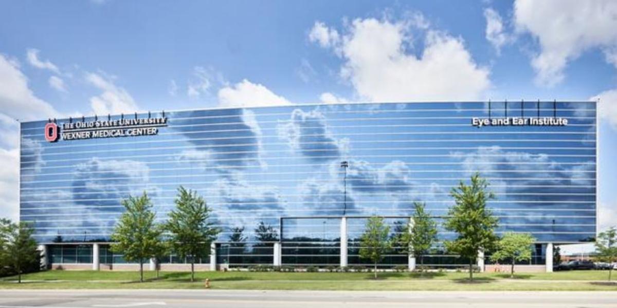 photo of eye and ear institute with clouds reflected off the facade