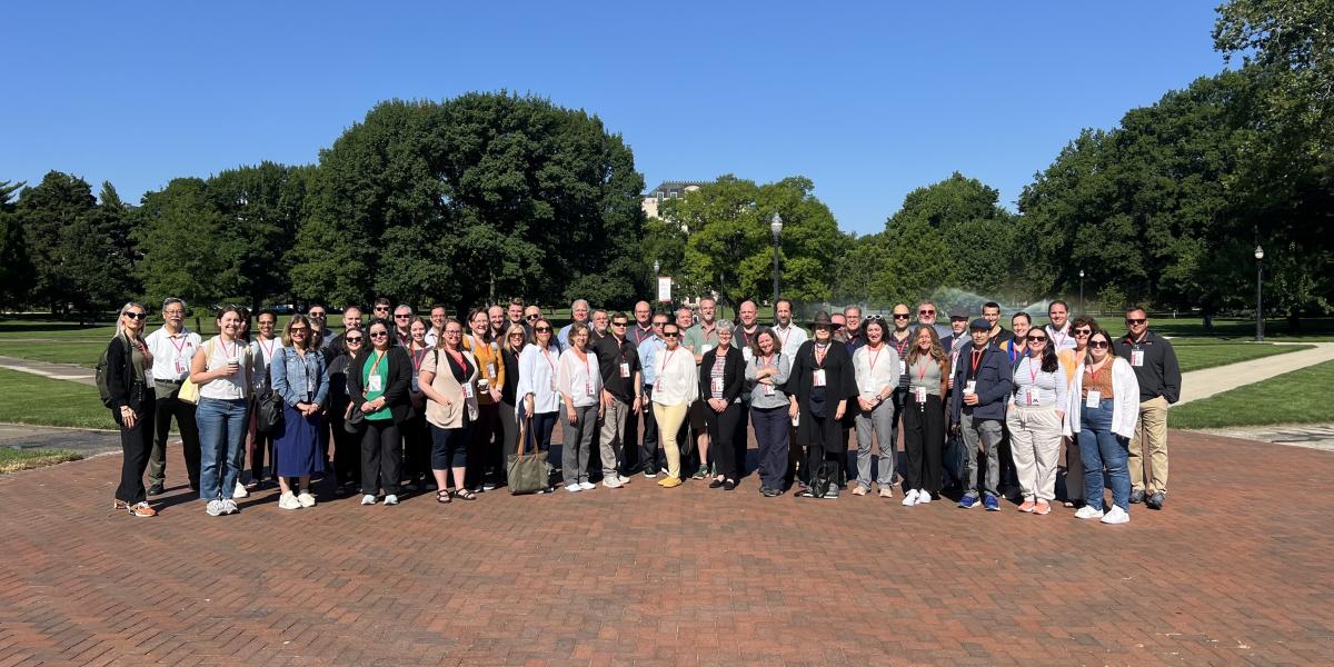 The HEFMA group smiling for a photo while standing outside in The Oval.