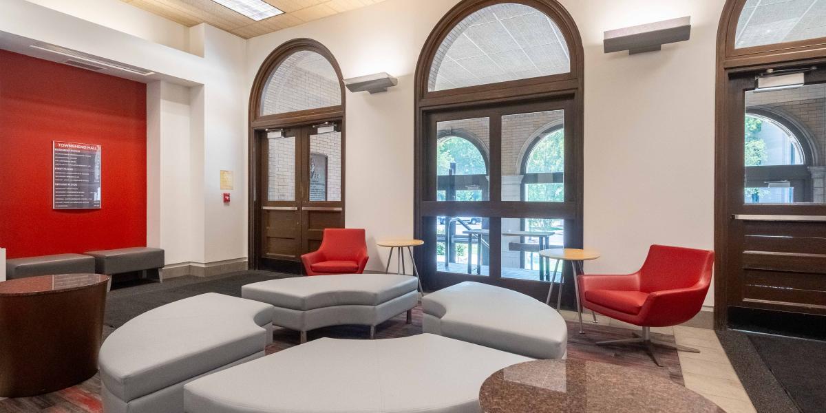 lobby with large windows and soft, moveable furniture.