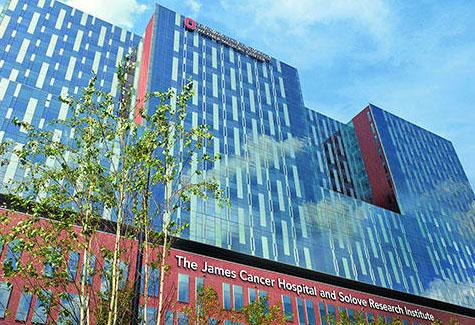 photo of the facade of the James Cancer Institute, from ground level looking up to the sky