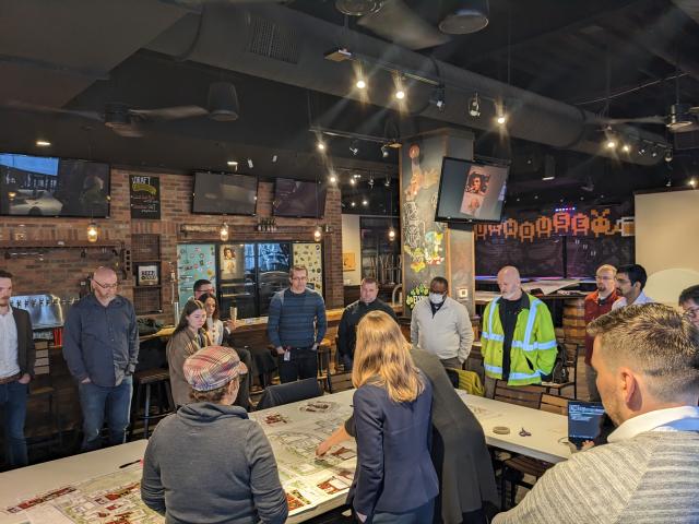 people standing around table