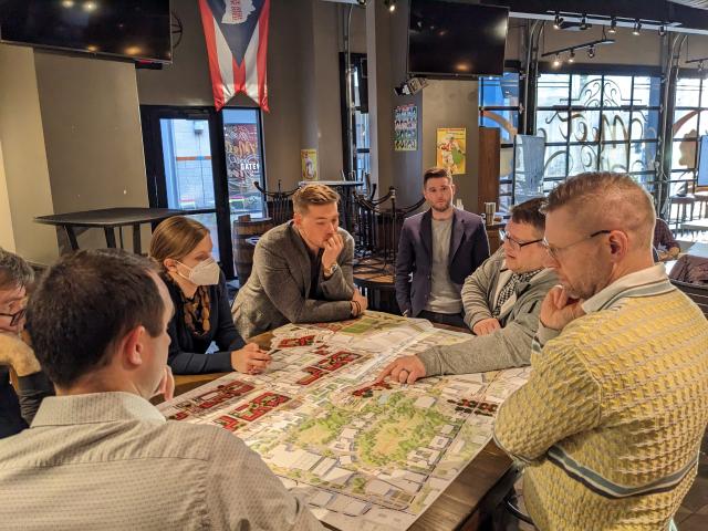people standing around maps