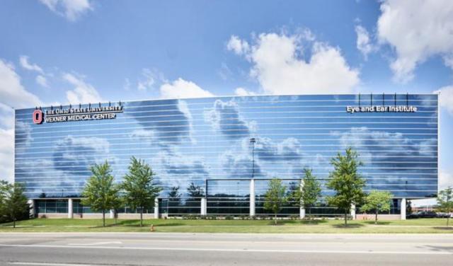 photo of eye and ear institute with clouds reflected off the facade