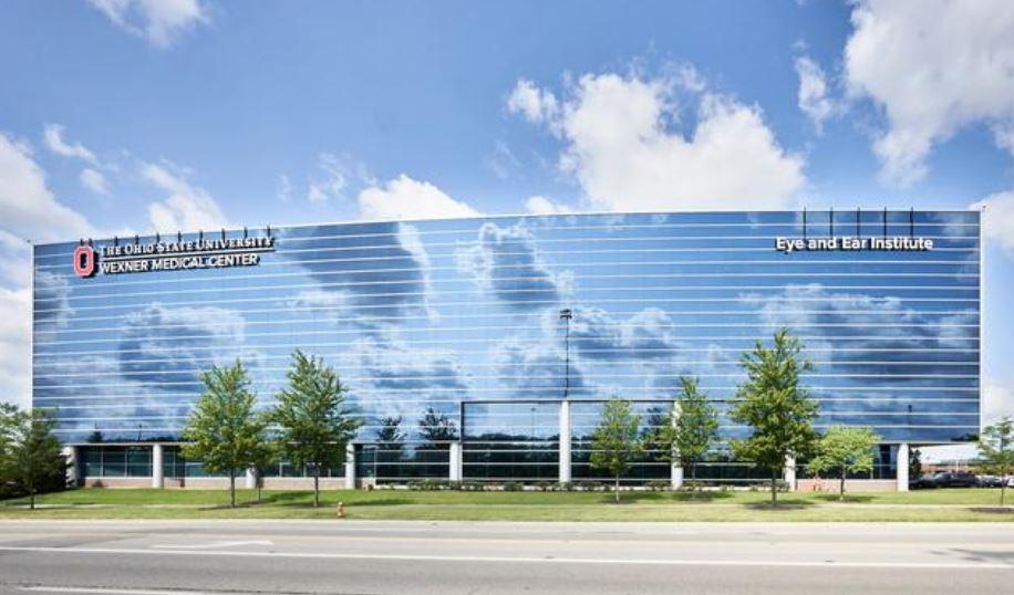 photo of eye and ear institute with clouds reflected off the facade